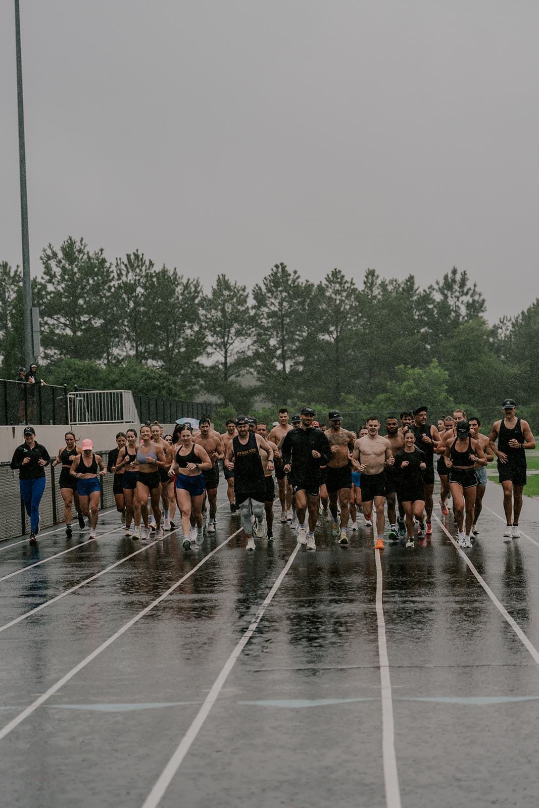 Threshold Lab community running together in the rain